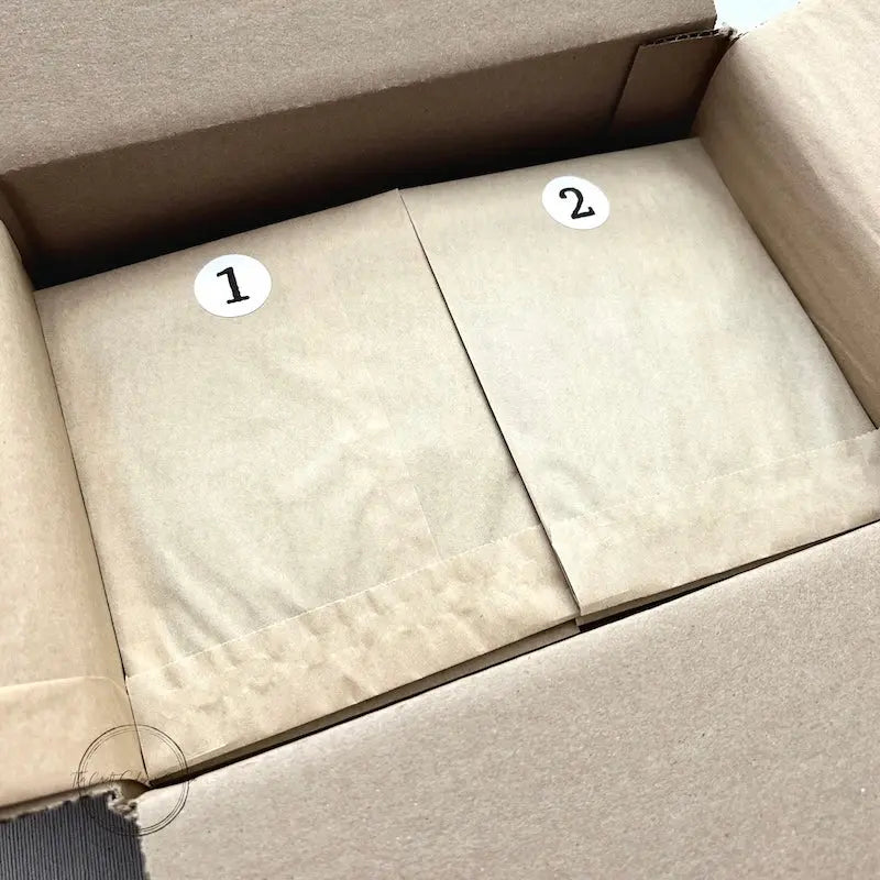 All of the card packages, that come in this Advent Calendar, are sitting in a box. Card kit numbers 1 and 2 sitting on top.
