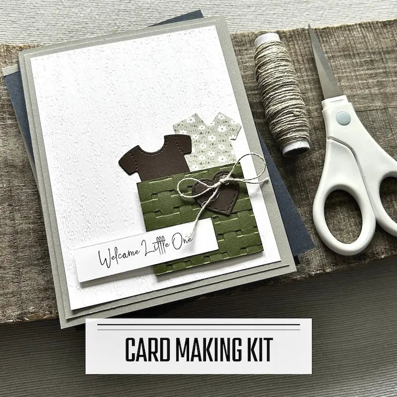 A DIY card making kit with cards to celebrate events such as birthday, a new baby, wedding etc. A finished card is sitting on blank cards with a roll of twine and a pair of scissors.