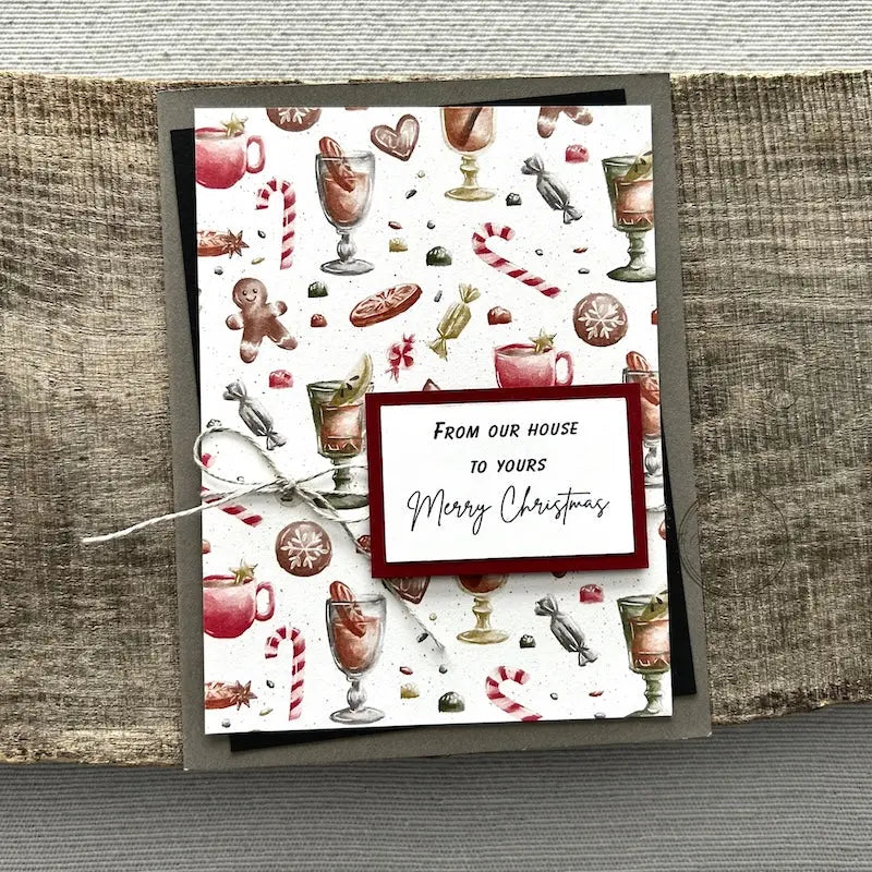 A finished card, from this card making kit, sitting on a wooden board.