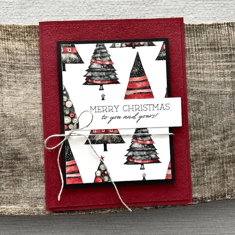 A finished card, from this card making kit, sitting on a wooden board.