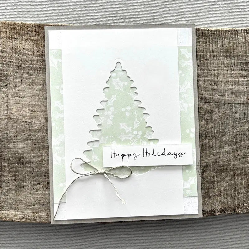 A finished card, from this card making kit, sitting on a wooden board.