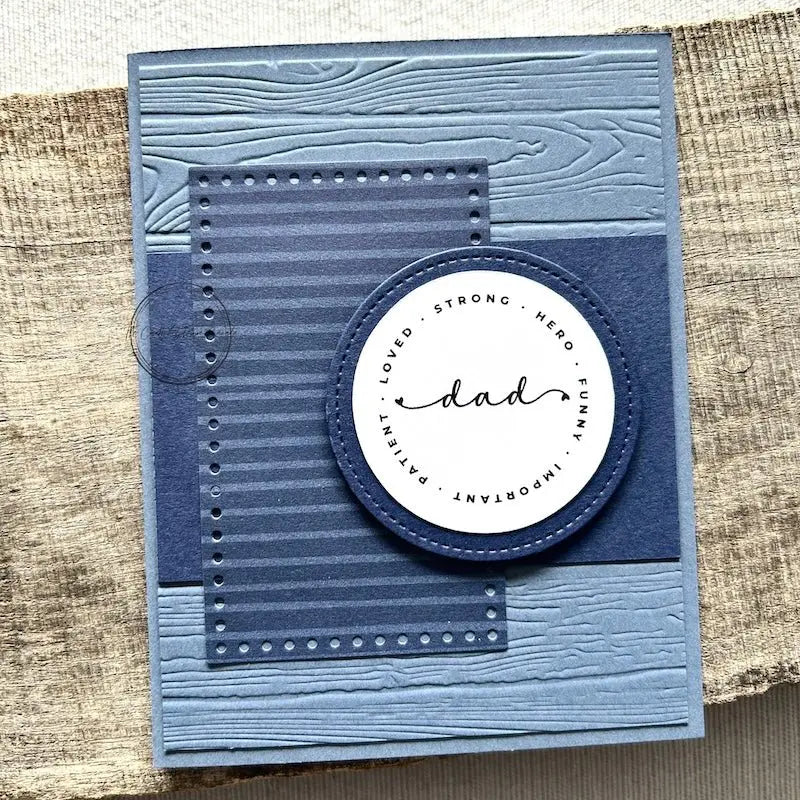 A finished card, from this card making kit, sitting on a wooden board.
