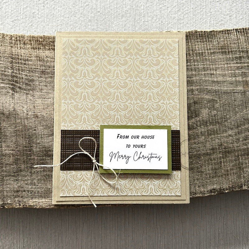 A finished card, from this card making kit, sitting on a wooden board.