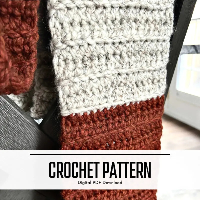 A digital pdf crochet pattern for a chunky wool scarf. The scarf is hanging over the back of a chair.