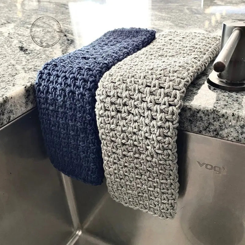 A dishcloths washcloths. made from this crochet pattern, are hanging over a sink.