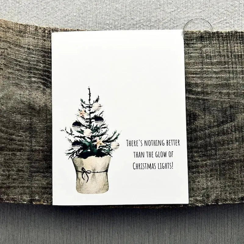 The printable greeting card is sitting on a wooden board with a pen and stamps.