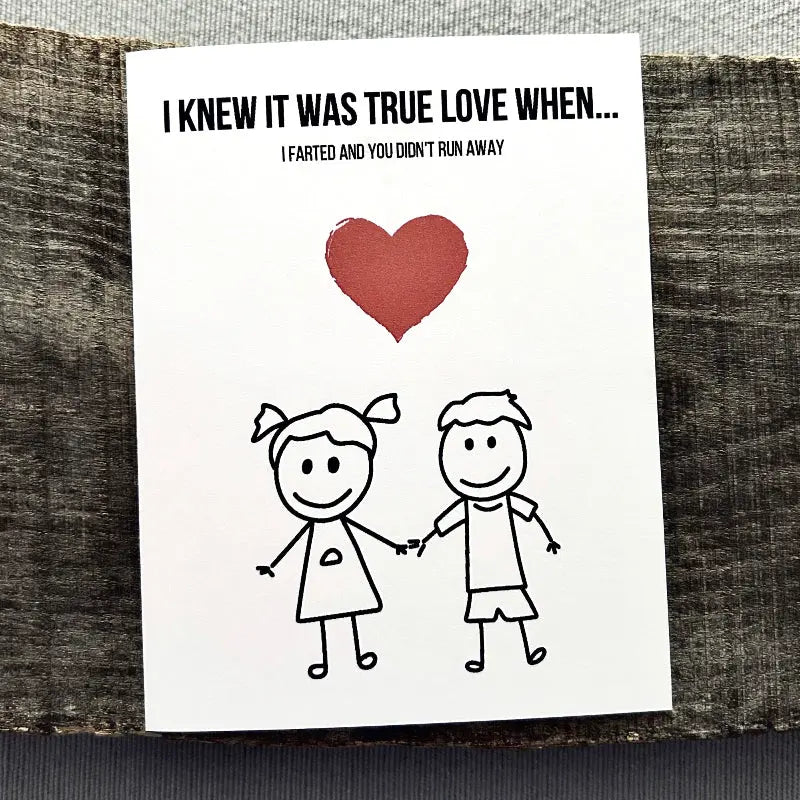 The printable greeting card is sitting on a wooden board.
