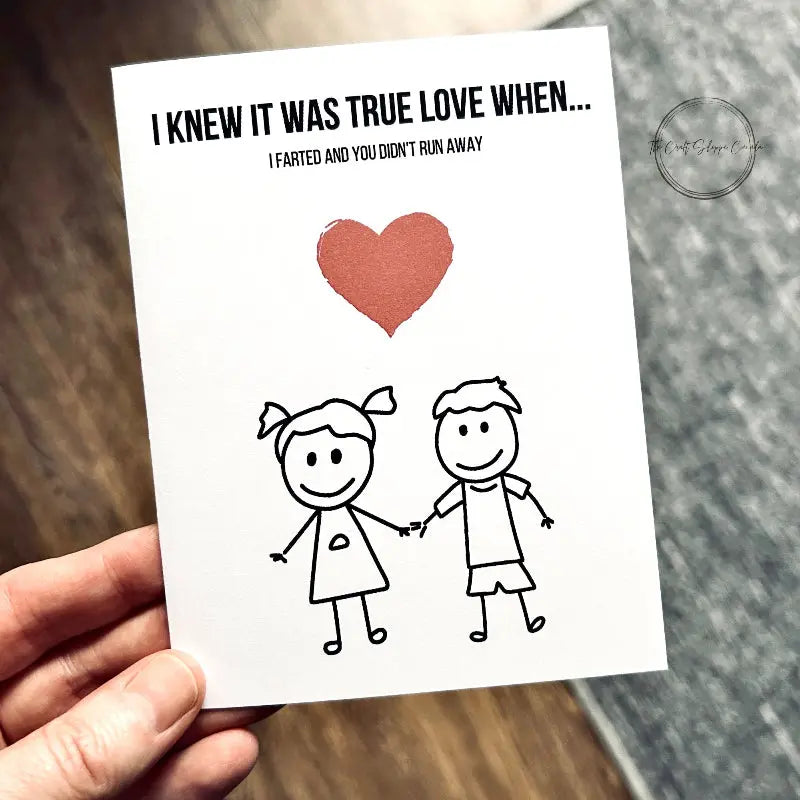 The printable greeting card is being held over a brown floor and grey carpet.