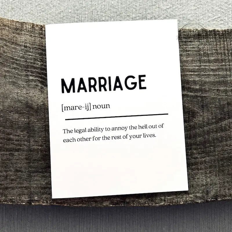The printable greeting card is sitting on a wooden board.