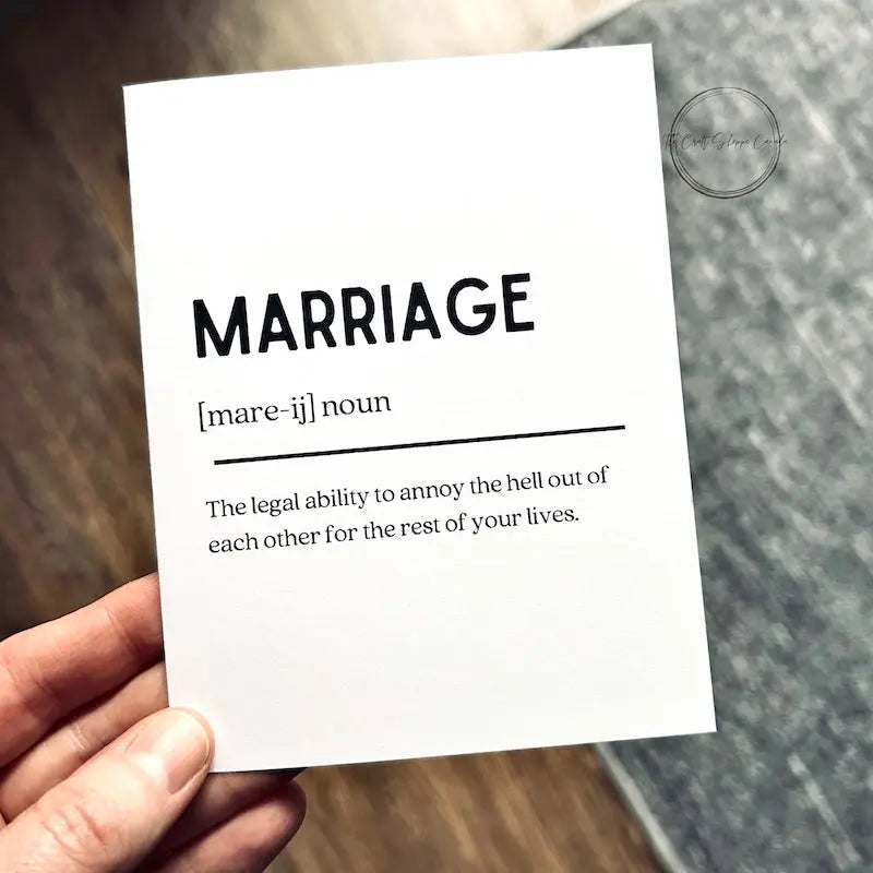 The printable greeting card is being held over a brown floor and grey carpet.