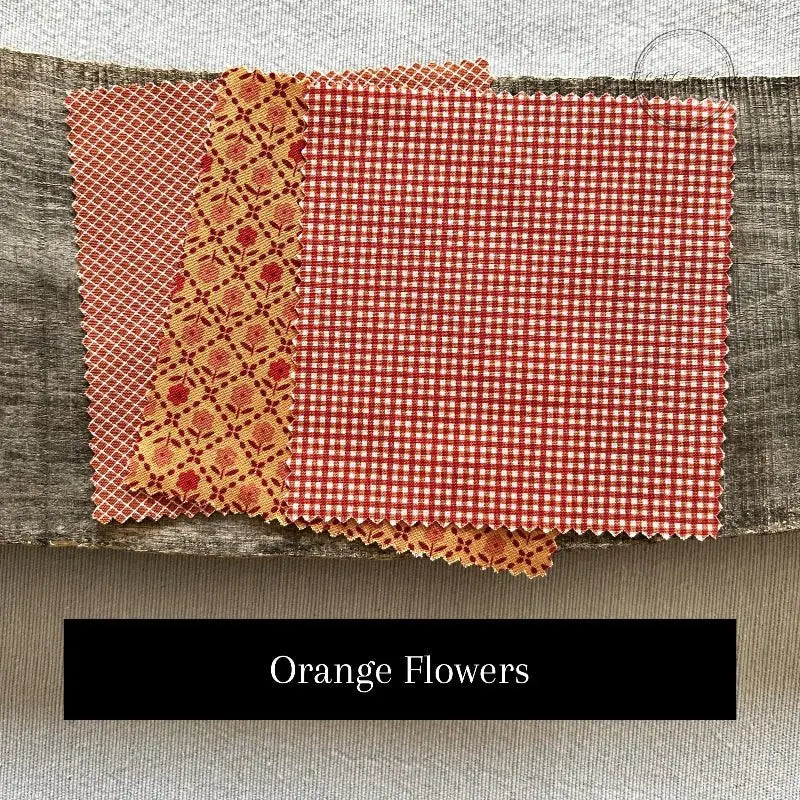 Fabric options for this sewing kit featuring a floral pattern with orange and white colours.