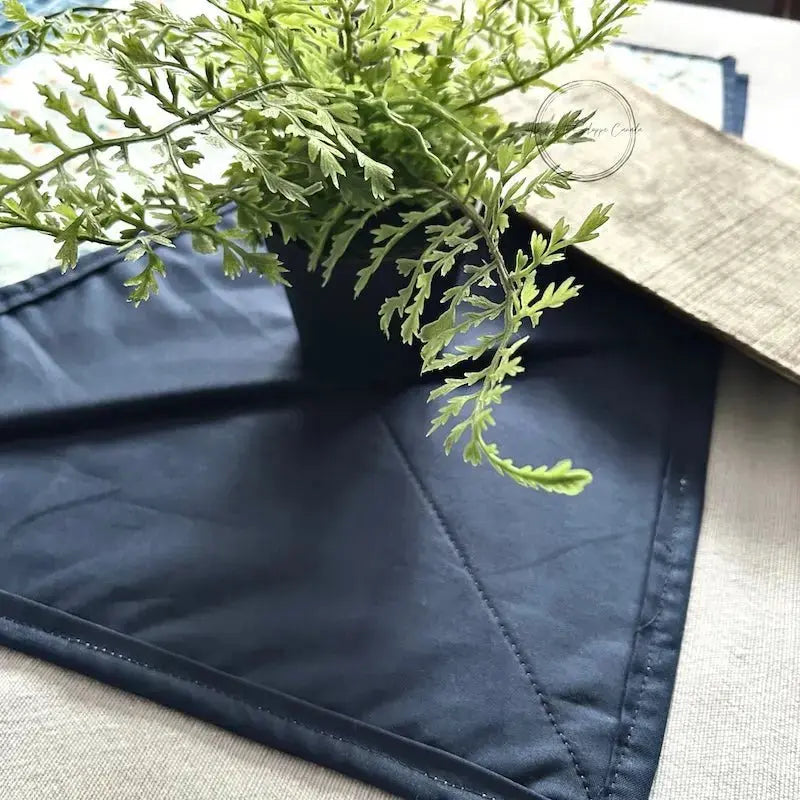 A quilted table runner, from this sewing kit, with the corner folded to show the back of the runner.
