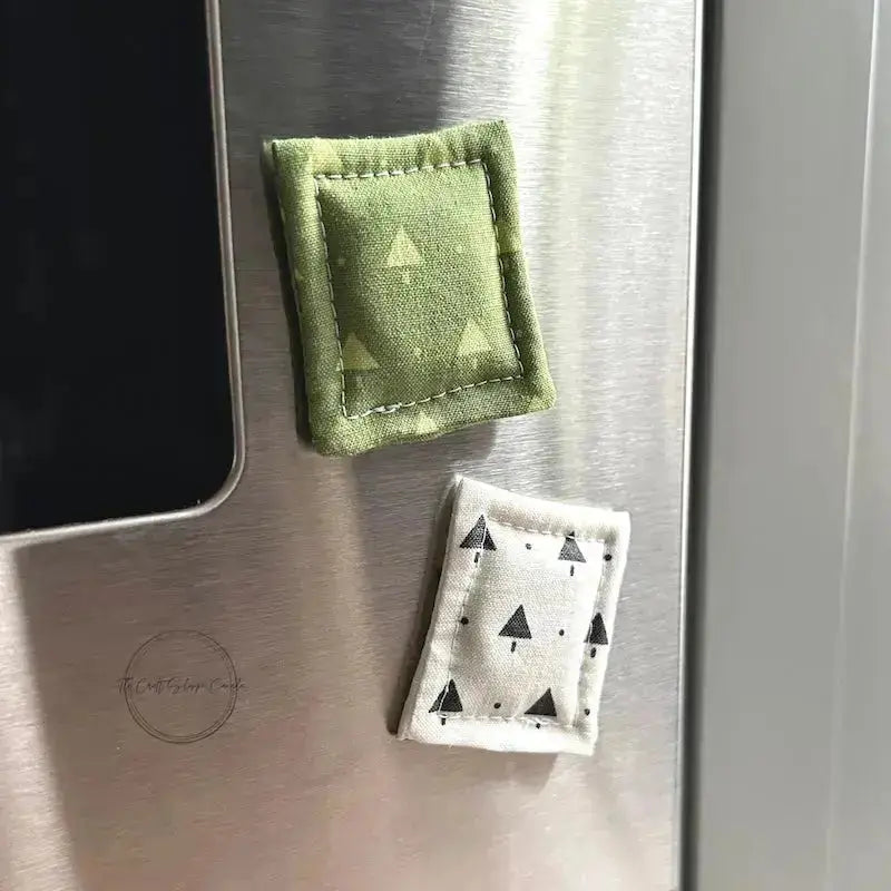 The needle minders can also be used as fridge/stove magnets. The two magnets are on a stove.