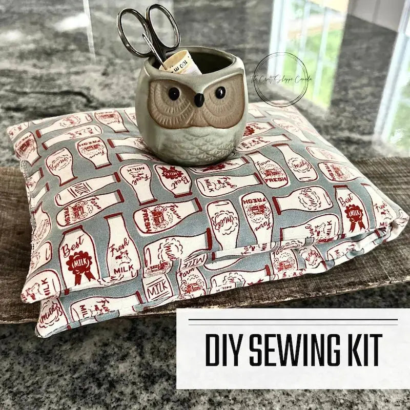 A DIY sewing kit for a rice bag heating pad. The rice bag is folded on a wooden board on a counter.