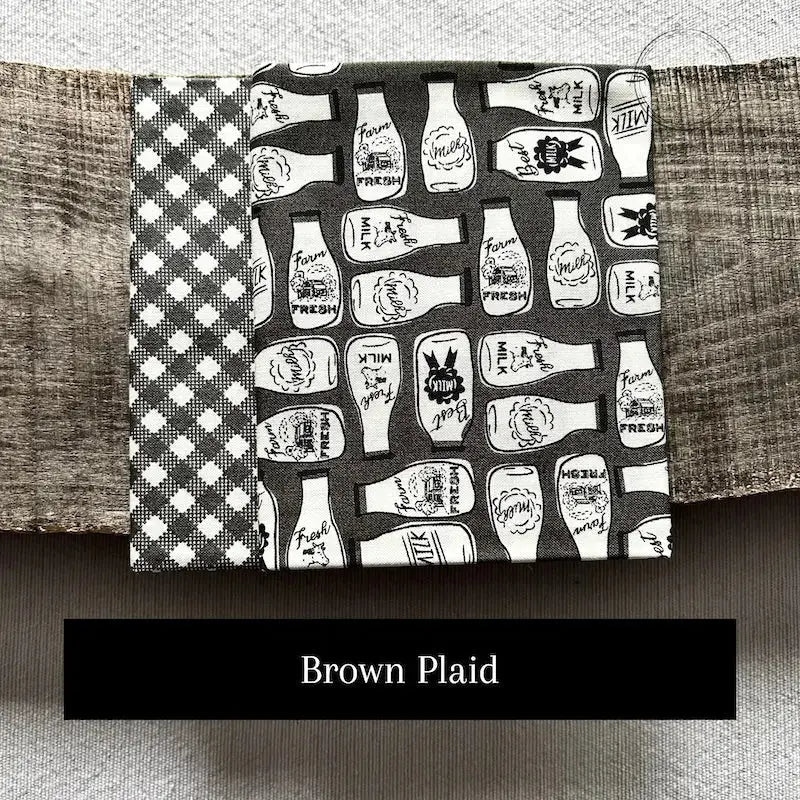 Fabric options for this sewing kit featuring a brown plaid pattern.