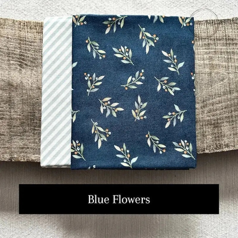 Fabric options for this sewing kit featuring a blue floral pattern.