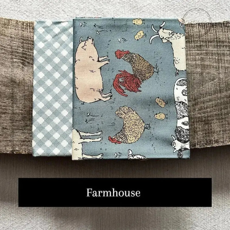 Fabric options for this sewing kit featuring a blue farmhouse pattern.