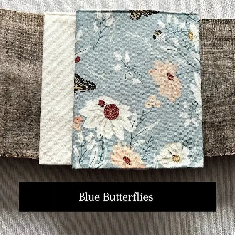 Fabric options for this sewing kit featuring a blue butterfly fabric pattern.