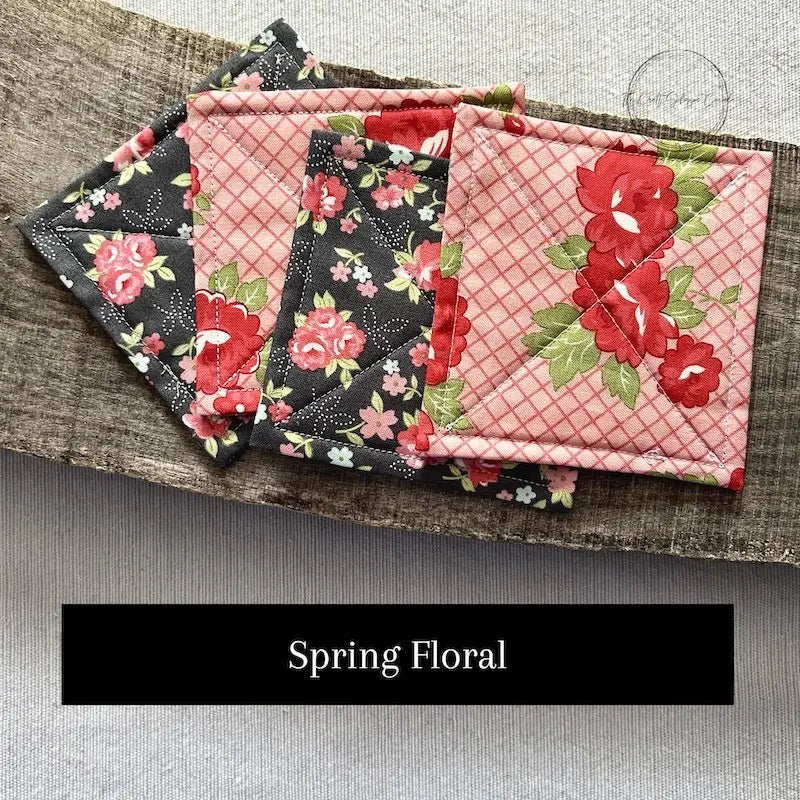 Fabric options for this sewing kit featuring a floral pattern of grey and red floral colours.