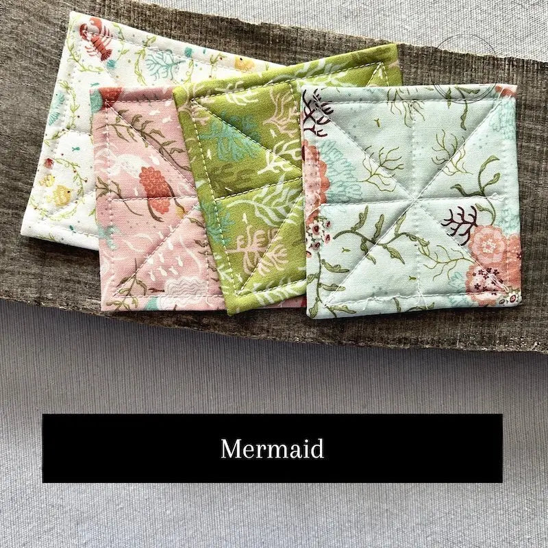 Fabric options for this sewing kit featuring a mermaid pattern of green and pink colours.