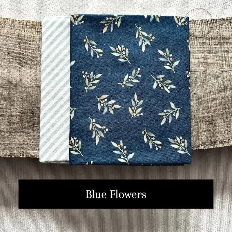 Fabric options for this sewing kit featuring a blue floral pattern.