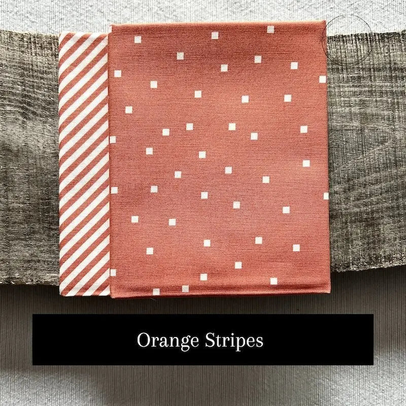 Fabric options for this sewing kit featuring an orange stripe pattern.