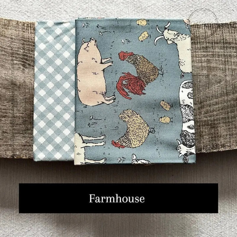 Fabric options for this sewing kit featuring a blue farmhouse pattern.