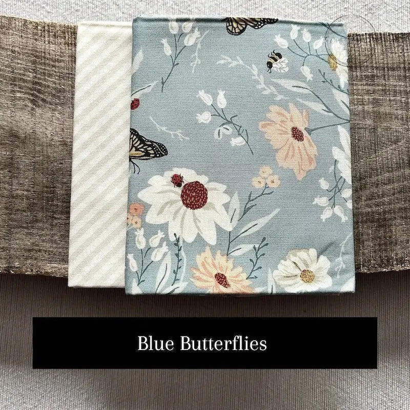 Fabric options for this sewing kit featuring a blue butterfly fabric pattern.