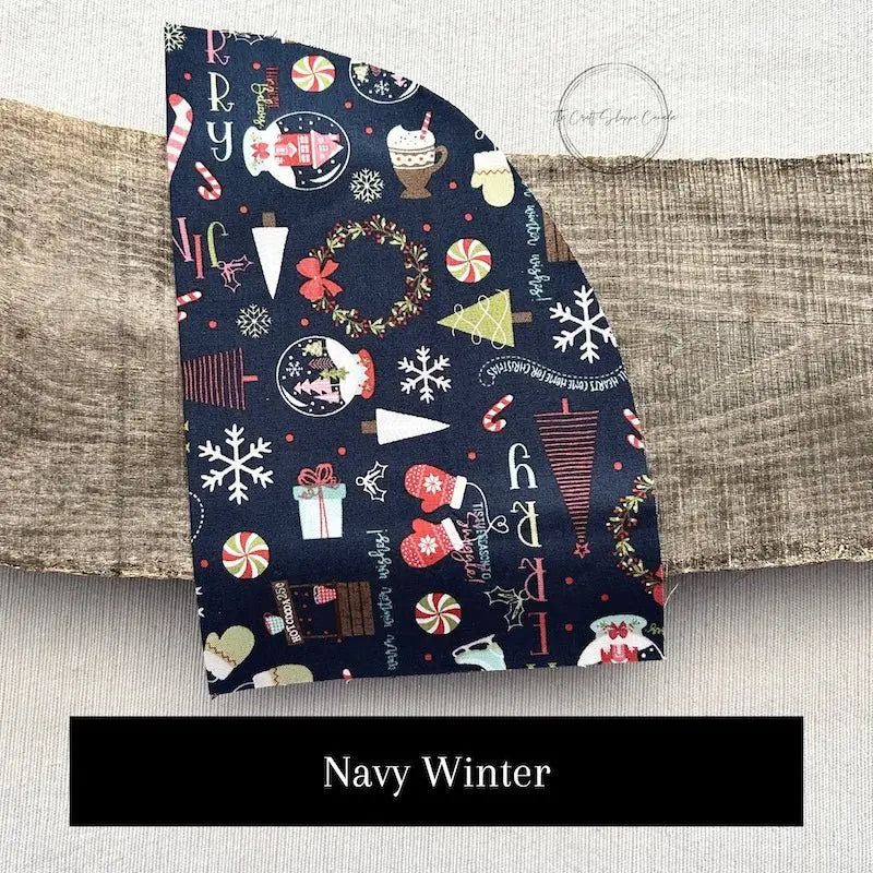 Fabric options for this sewing kit featuring a Christmas pattern of navy blue and red colours.