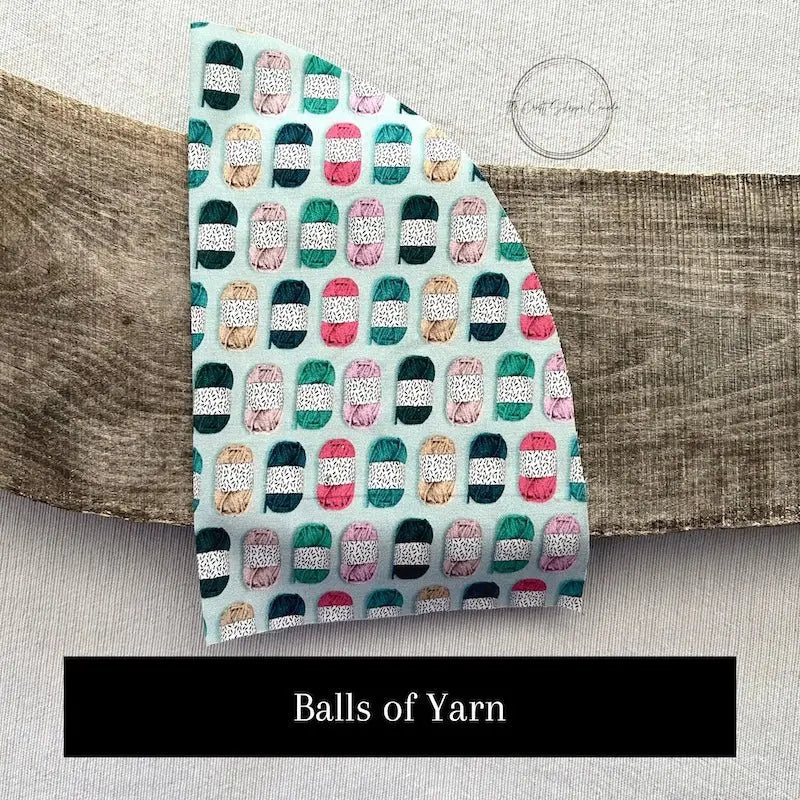 Fabric options for this sewing kit featuring balls of yarn with mint green and pink colours.