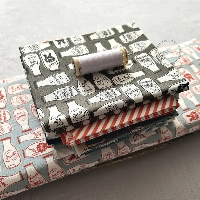 Fabric that would be used in this sewing pattern is sitting on top of a finished rice bag.