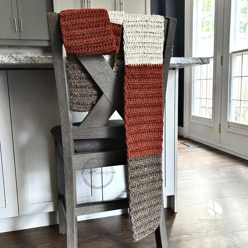 The finished scarf hanging over a chair - The Craft Shoppe Canada