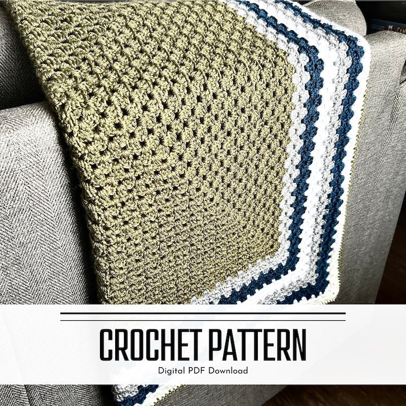 A digital crochet pattern for a couch throw blanket. The finished blanket is hanging over a couch - The Craft Shoppe Canada