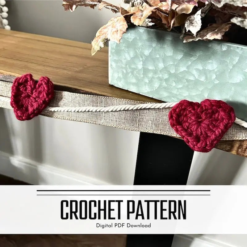 A digital PDF crochet pattern for a string of hearts garland. The garland is lying over a wooden table.