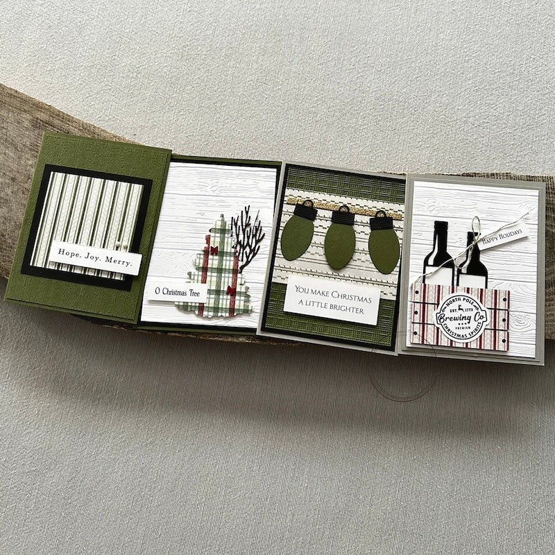 There are 4 finished cards, sitting on a wooden board, to show the finished cards that are included in this card making kit. There are 4 designs but you will get 3 of each design in your kit.