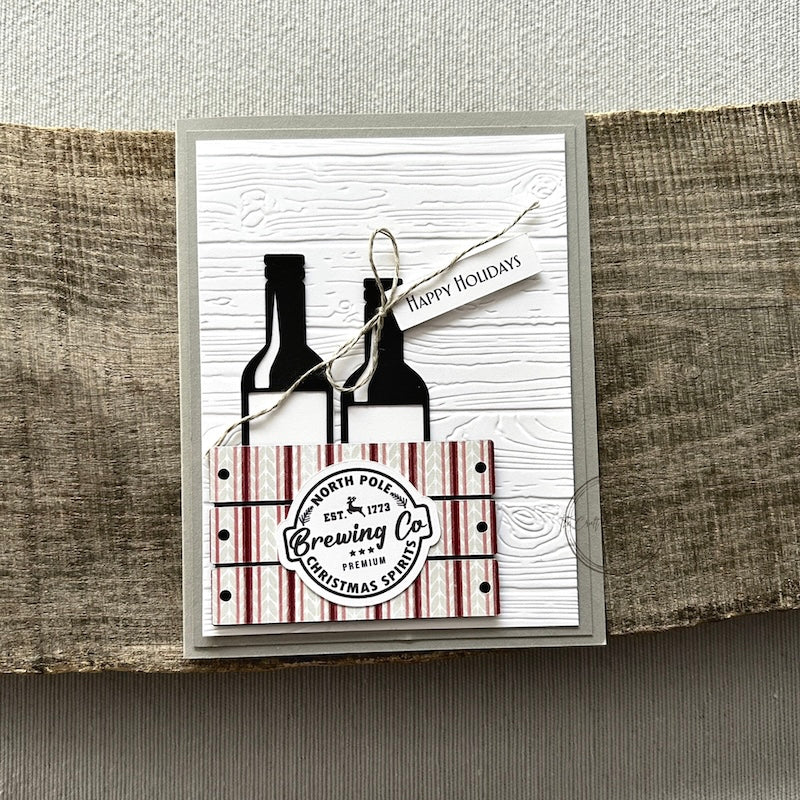 A finished card, from this card making kit, sitting on a wooden board.
