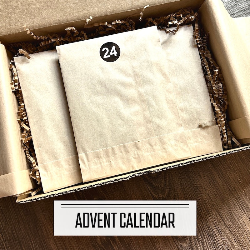 A DIY card making kit Advent Calendar. The numbered packages are sitting inside a box.