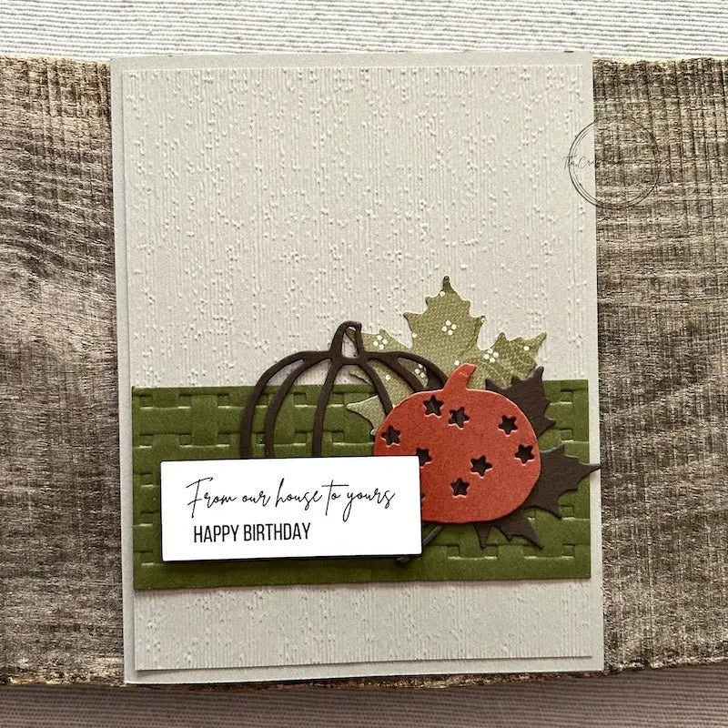 A finished card, from this card making kit, sitting on a wooden board.