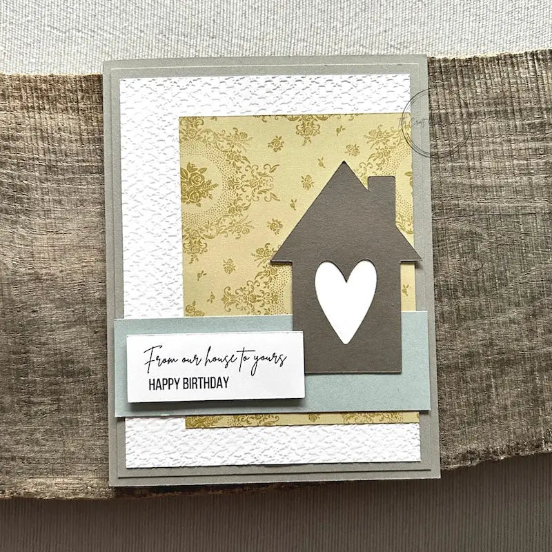 A finished card, from this card making kit, sitting on a wooden board.