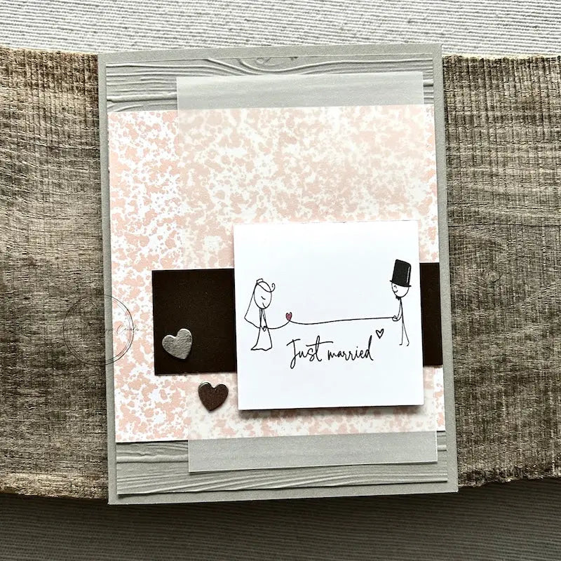 A finished card, from this card making kit, sitting on a wooden board.