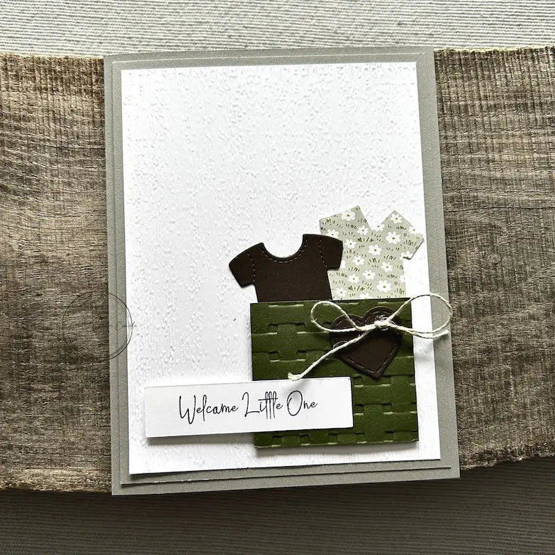 A finished card, from this card making kit, sitting on a wooden board.