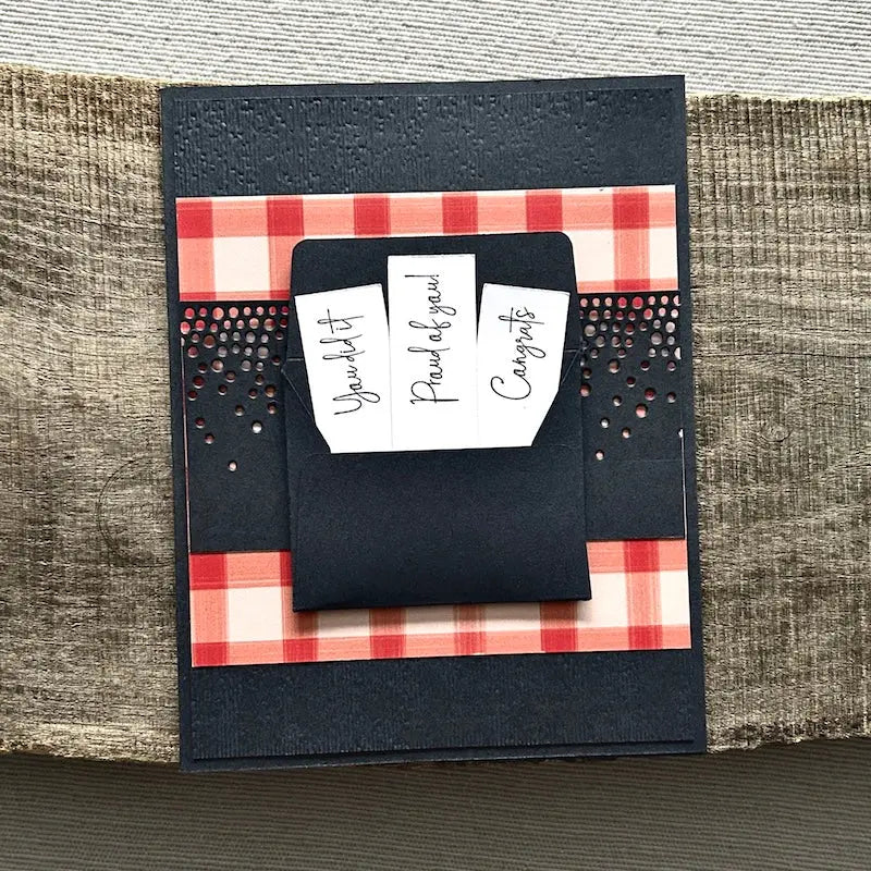 A finished card, from this card making kit, sitting on a wooden board.