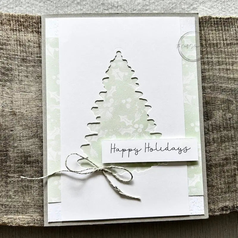 A finished card, from this card making kit, sitting on a wooden board.