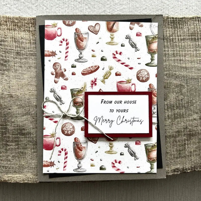 A finished card, from this card making kit, sitting on a wooden board.