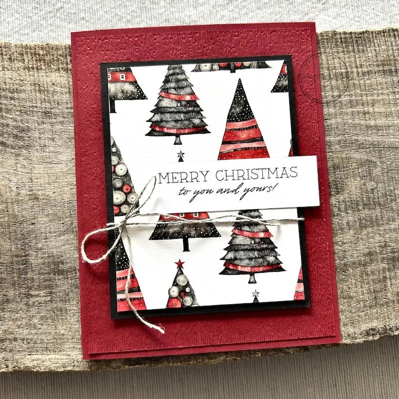 A finished card, from this card making kit, sitting on a wooden board. 