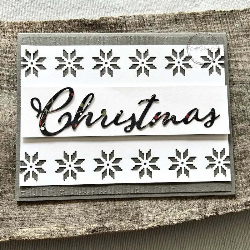 A finished card, from this card making kit, sitting on a wooden board. 