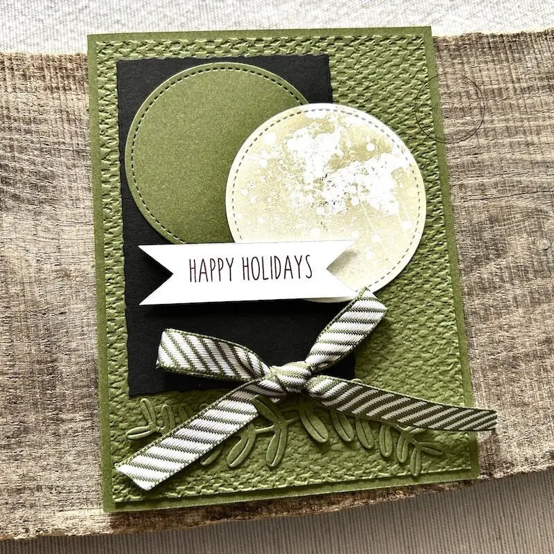 A finished card, from this card making kit, sitting on a wooden board. 