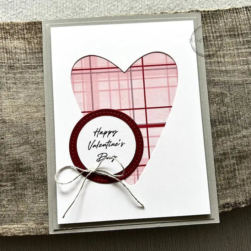 A finished card, from this card making kit, sitting on a wooden board.