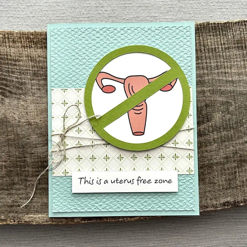 A finished card, from this card making kit, sitting on a wooden board.