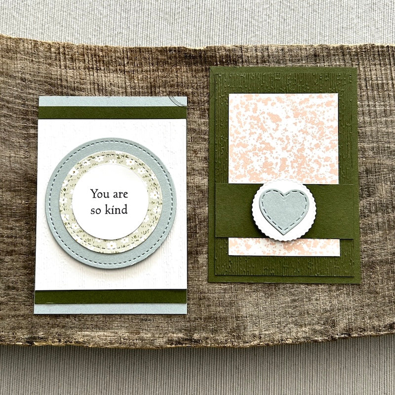 Finished Valentines, from this card making kit, sitting on a wooden board.